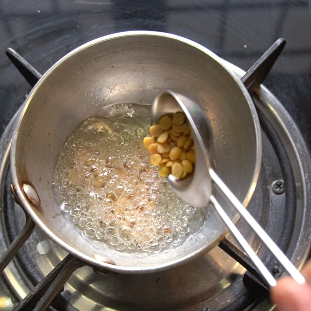 To the hot oil, add 1 tsp toor dal